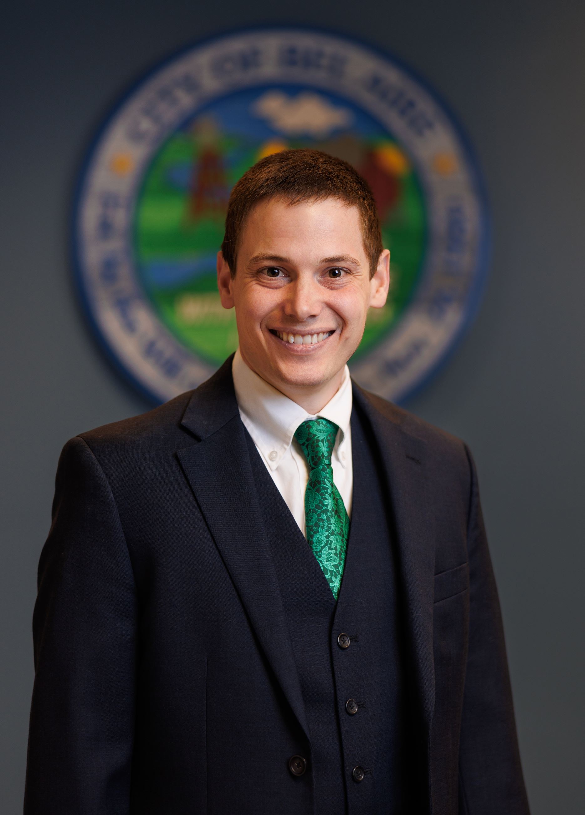 Brandon McIntosh Bel Aire City Council Member in a black suit with green tie